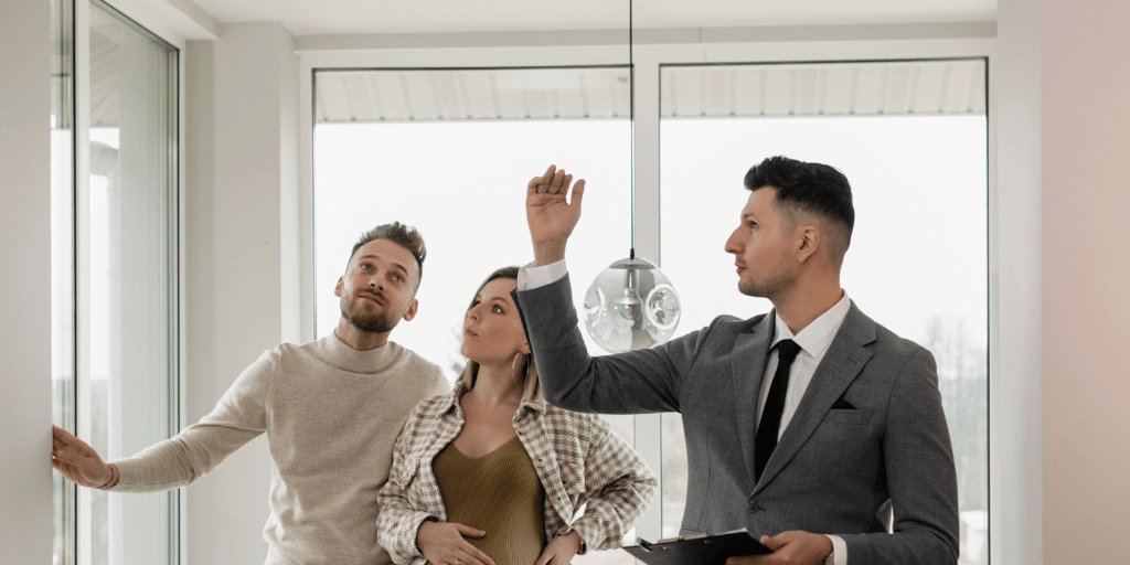 Estate agent showing couple around a living space for rent