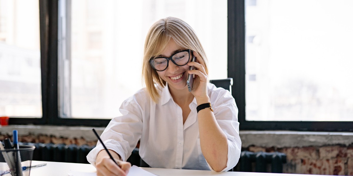 Woman on her mobile phone at her desk office.