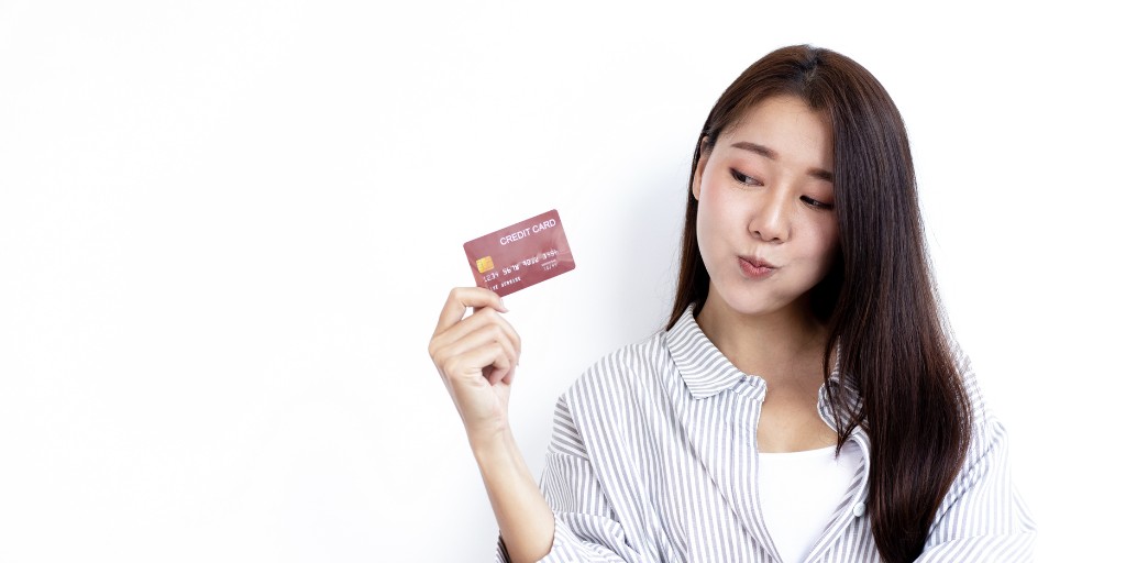 Female student holding a credit card