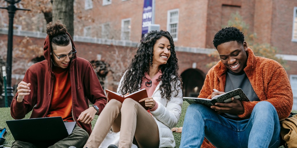 Students studying together outside and having fun