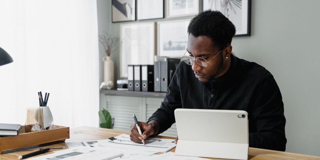 Man working on his accounts at his desk.